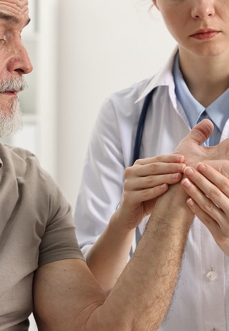 A medical professional assessing wrist mobility